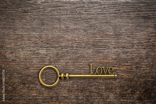 Vintage key for love on wood background with space. Valentine ba