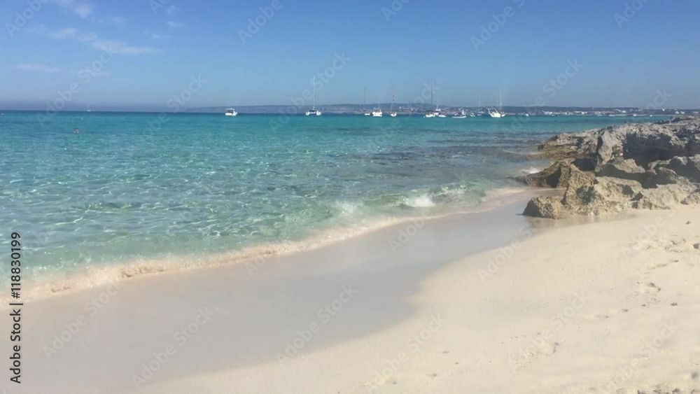 Awesome Cristal Blue Water Beach in Formentera Spain in a sunny day with very small waves. Awesome Cristal Blue Water Beach in Formentera Spain in a sunny day with very small waves.
