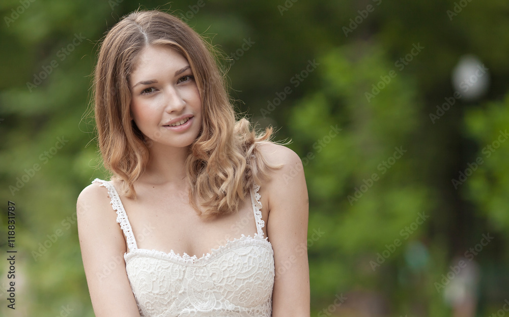 Portrait Of Young Beautiful Woman. beautiful young brunette fashion model posing outdoor. Summer outdoor portrait. Focus on woman, blurred background
