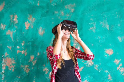 technology, entertainment and people concept - happy young woman with virtual reality headset or 3d glasses © satura_