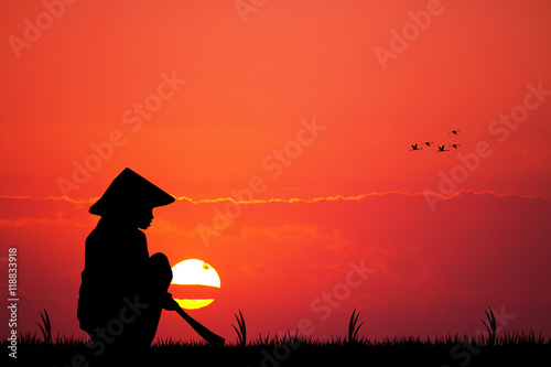 Asian farmer at sunset