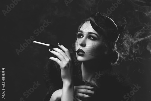 Photos Beautiful girl with smoky eyes and red lips holding cigarette