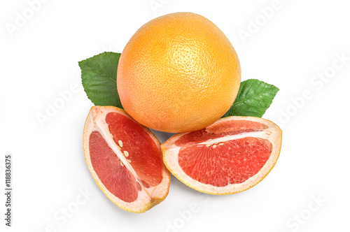 whole grapefruit and two wedges on white with green leaf
