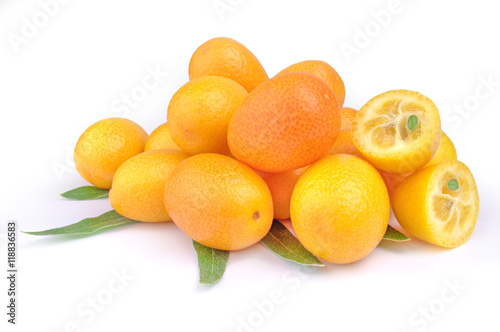 Pile of kumquat and two its half isolated on white background with leaves