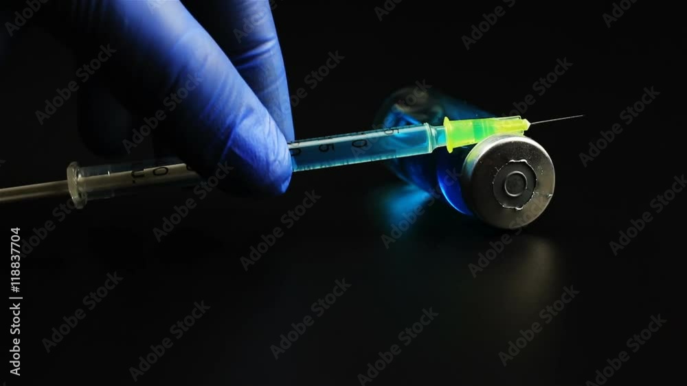 Insulin syringe put on vial on black background Stock Video | Adobe Stock