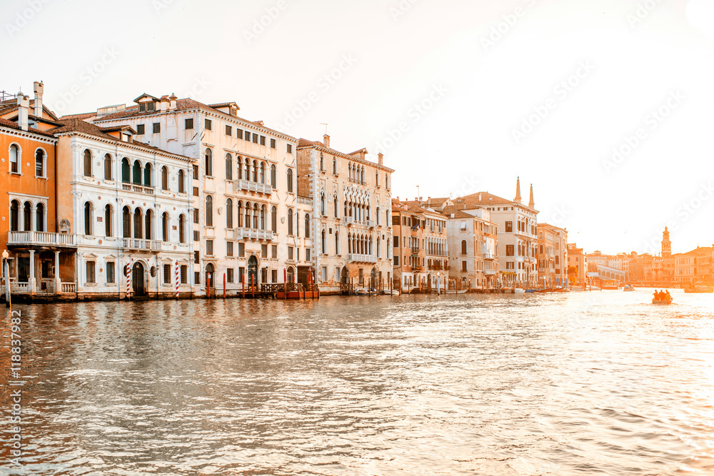 Beautiful waterfront with gothic buildings and boats on Gran canal at the sunrise