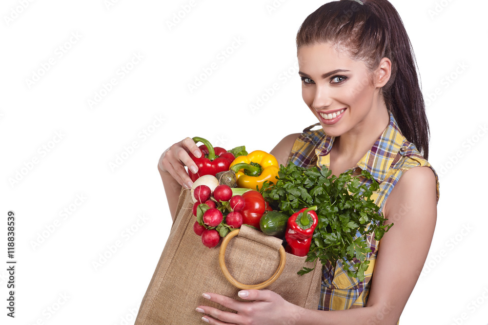 Isolated woman holding a shopping bag full of vegetables Isolated woman holding a shopping bag full of vegetables