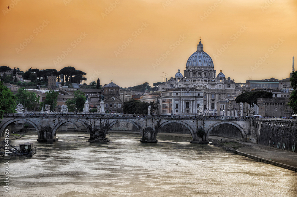 Sunset on the river Tiber with a view of the Basilica of St. Peter in Rome.