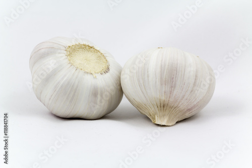 Fresh garlic bulbs close-up lie on a light background 