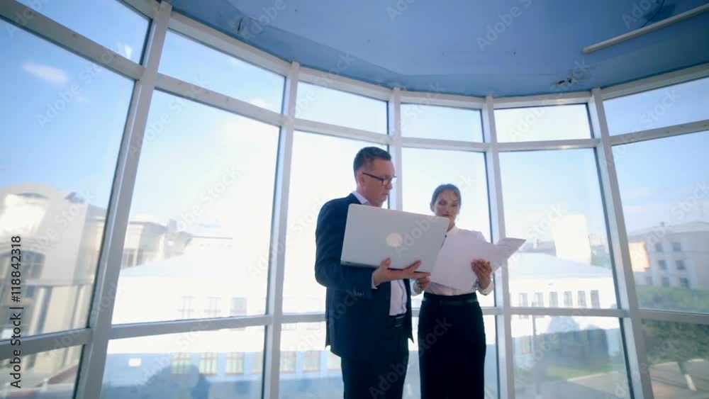Two young caucasian businessman having a meeting in modern office building. Steadicam. HD. Two young caucasian businessman having a meeting in modern office building. Steadicam. HD.