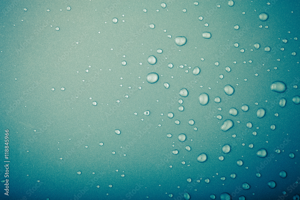 Drops of water on a color background. Green. Toned