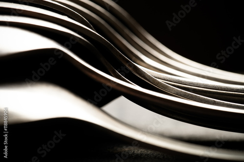 Lot of metal cutlery on a black background. Selective focus. Sha