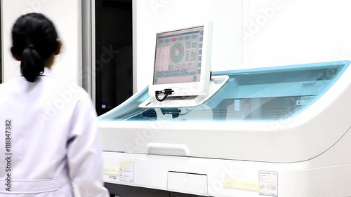 Wallpaper Mural Woman working in the modern medical laboratory. Medical staff working with automatic machine. Analysis blood at hospital laboratory. Doctor testing blood samples in a robotic machine with display.  Torontodigital.ca