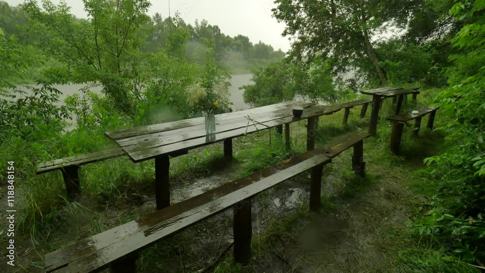 Old Wooden Tables and Benches in the Pouring Rain Tourist Base Lush Green Trees Forest Rain is Washing Off All Traces Cloudy Rainy Summer Day at the River Old Wooden Tables and Benches in the Pouring Rain Tourist Base Lush Green Trees Forest Rain is Washing Off All Traces Cloudy Rainy Summer Day at the River