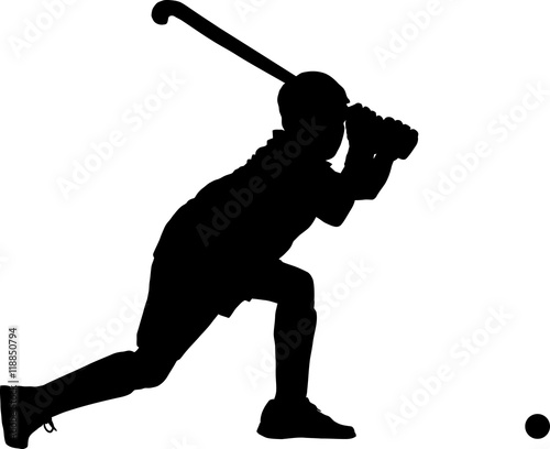 Silhouette of boy hockey player hitting ball