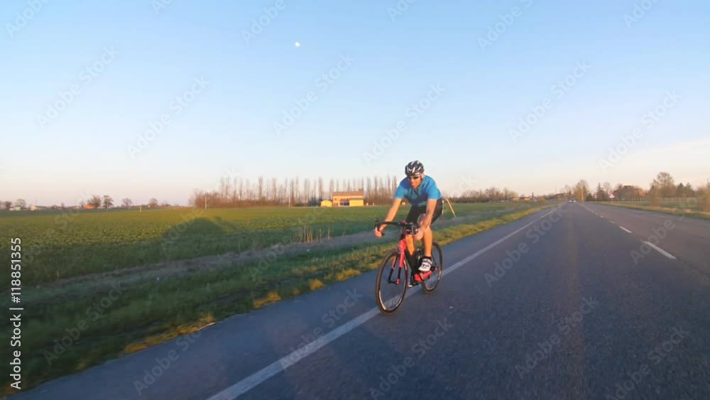 man riding bicycle working out slow motion outdoor from camera car tracking shot man riding bicycle working out slow motion outdoor from camera car tracking shot
