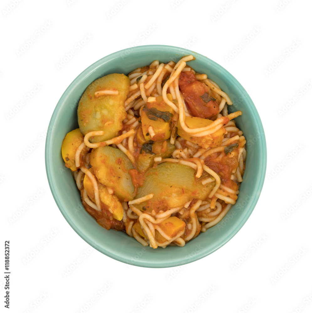 Angel hair pasta with zucchini and spinach in a bowl on a white background. Angel hair pasta with zucchini and spinach in a bowl on a white background.
