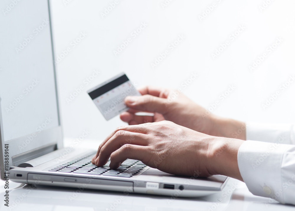 Man with credit card using a laptop computer for internet shopping Man with credit card using a laptop computer for internet shopping