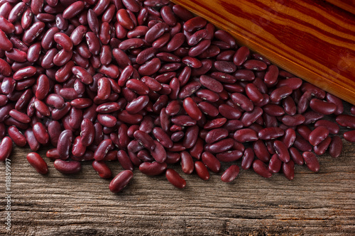 Red kidney beans on grunge wooden background.