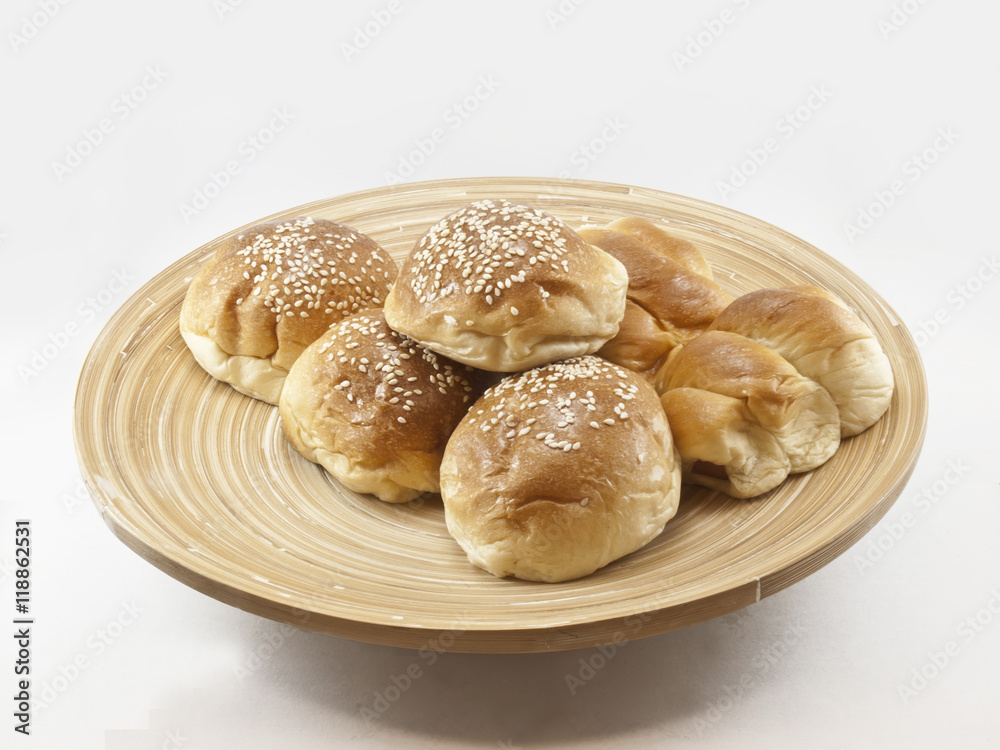 The pile of breads in the wooden dish.