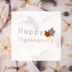 Happy thanksgiving on Autumn flowers and leaves toning background
