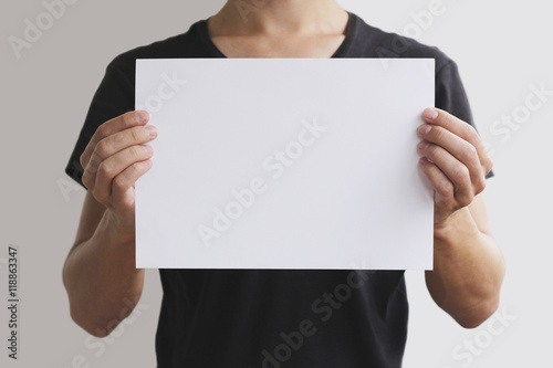 Man holding white A4 paper horizontally