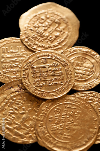 Ancient golden islamic coins with arabic letters