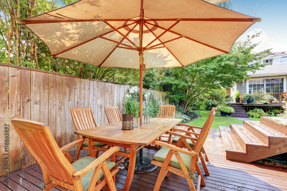 Obraz premium House exterior. Wooden patio table set with umbrella