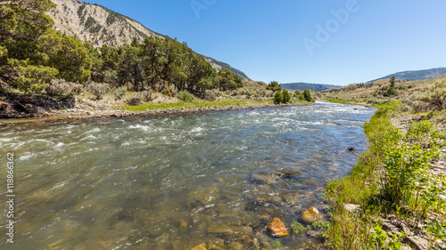 The flow of water among the rocks. Beautiful brown stones on the river bottom. Fast flowing river on the background of the rocky coast. Boiling River Trail, Yellowstone National Park, Wyoming 