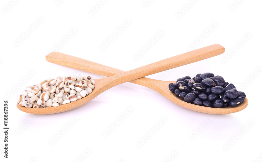 black eyed peas beans and millet grains in wooden spoon isolated black eyed peas beans and millet grains in wooden spoon isolated