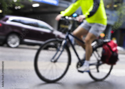 Blurred image of a cyclist riding through the city