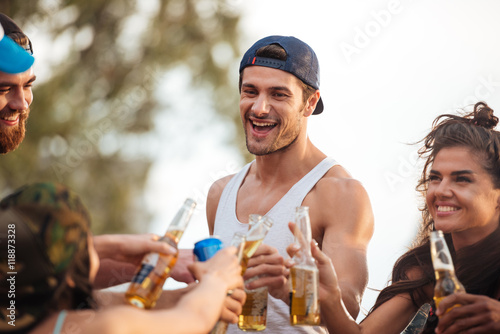 Man laughing and celebrating with friends outsoors