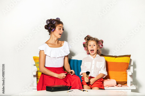 Little girl playing with her mom's makeup