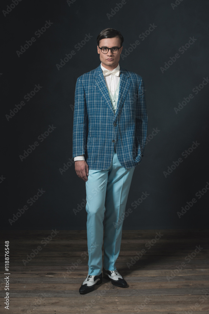 Retro 1920s dandy man wearing blue checkered jacket and pants. Retro 1920s dandy man wearing blue checkered jacket and pants.