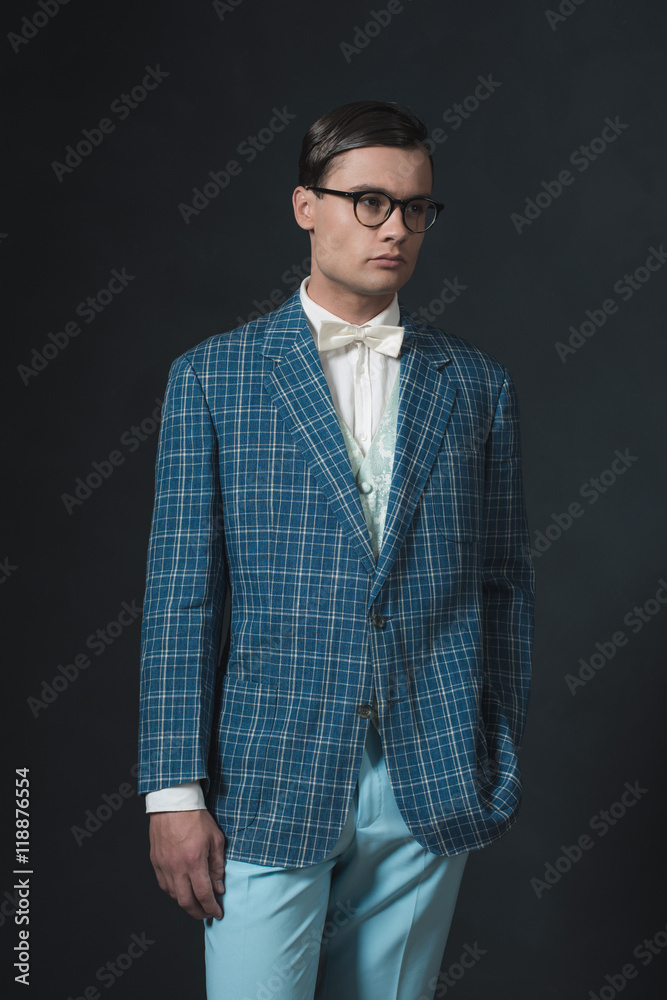Retro 1920s dandy man wearing blue checkered jacket and pants. Retro 1920s dandy man wearing blue checkered jacket and pants.