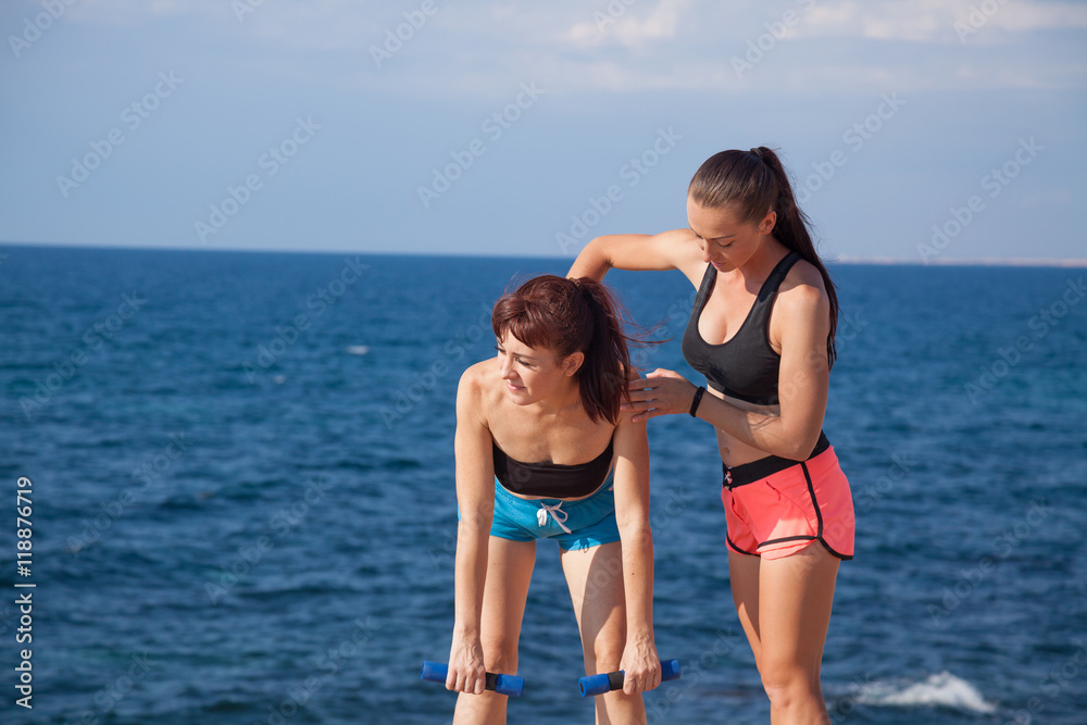trainer helps the girl to do the exercises trainer helps the girl to do the exercises