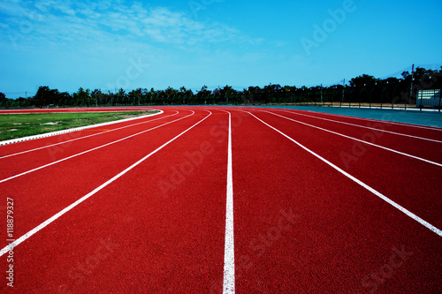 athletic  background  compete  competition  course  exercise  field  ground  lane  number  outdoor  race  racetrack  red  rubber  run  sport  stadium  start  surface  texture  track  white