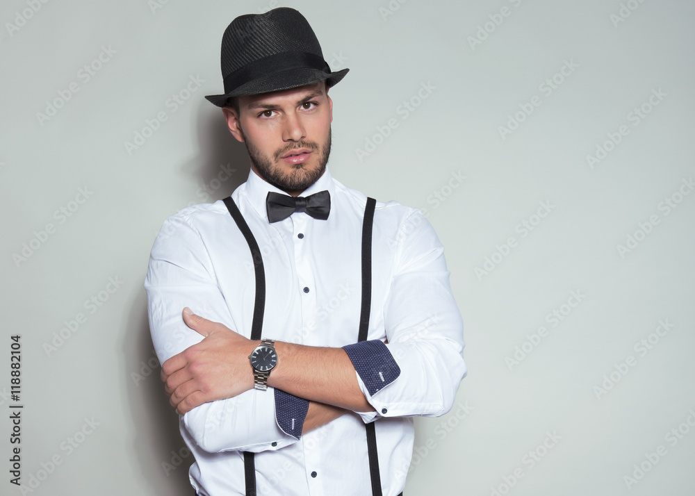 handsome young man wearing hat, suspenders, bow tie and a watch
handsome young man wearing hat, suspenders, bow tie and a watch