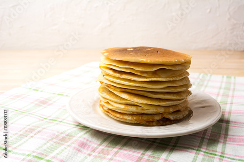 Stack of breakfast pancakes on the white plate