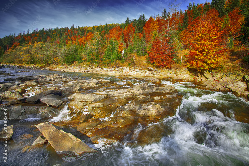 Mountain fast flowing river stream of water in the rocks at autu Mountain fast flowing river stream of water in the rocks at autu