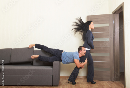 Man desperately clinging to the leg of a woman