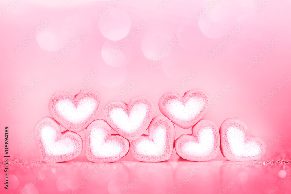 marshmallow heart shape on pink background with love concept