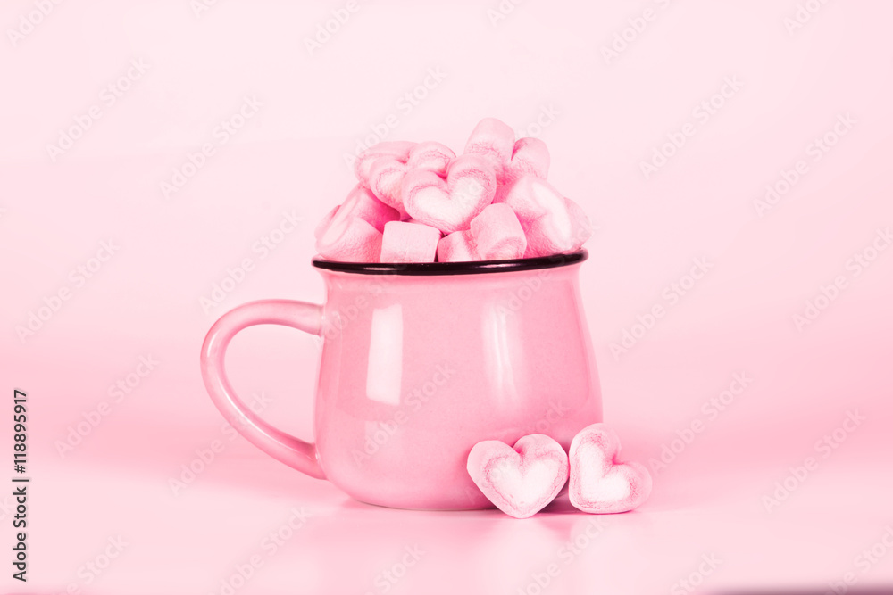 marshmallow heart shape in cup on pink background marshmallow heart shape in cup on pink background