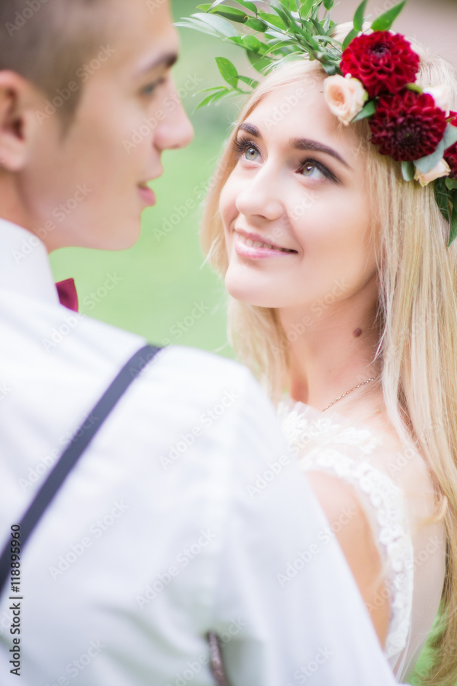Bride admires attractive groom while standing before him Bride admires attractive groom while standing before him