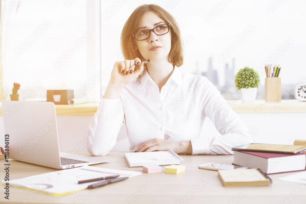 Daydreaming businesswoman in office