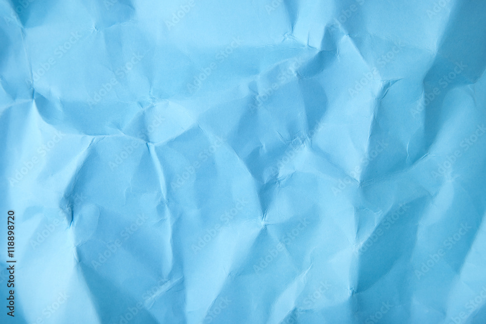 Obraz premium A full page of screwed up bright blue wrapping paper texture