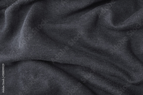 A full page of ripples of dark grey fleece fabric texture