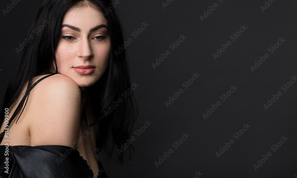 Portrait of happy smiling beautiful brunnette model woman posing in black lingerie or underwear isolated on black background in studio. Portrait of happy smiling beautiful brunnette model woman posing in black lingerie or underwear isolated on black background in studio.