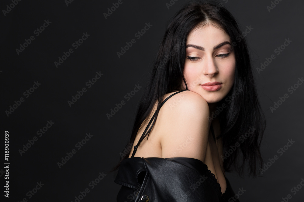 Portrait of beautiful brunnette model woman having photo session for fashion or vogue magazine isolated on black background in studio. Portrait of beautiful brunnette model woman having photo session for fashion or vogue magazine isolated on black background in studio.