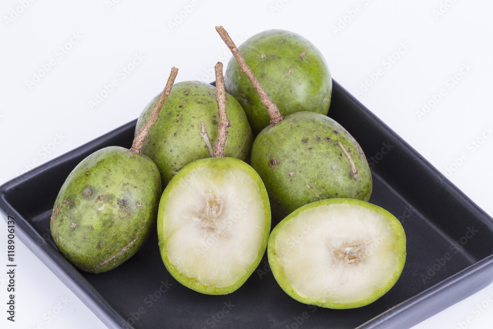 Fresh Hog plum (Wild Mango) on black dish Fresh Hog plum (Wild Mango) on black dish